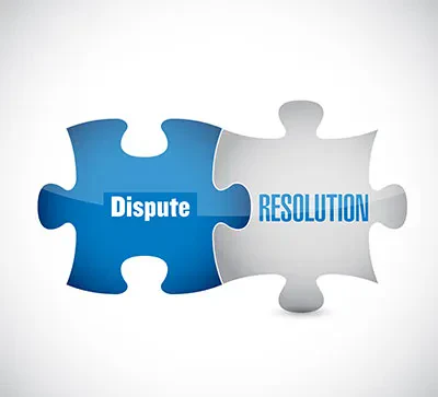 Two interlocking puzzle pieces, one blue labeled 'Dispute' and one silver labeled 'RESOLUTION', fitting together to symbolize finding a solution.