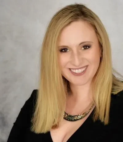A professional headshot of Share-Lynn Cuomo Shore.