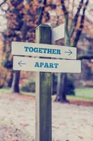 A signpost with arrows pointing towards "Together" and "Apart," symbolizing choices in relationships.