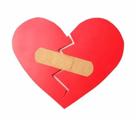 A broken heart symbol with a bandage applied, representing healing and recovery from emotional pain.