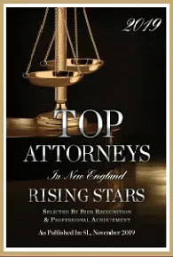 A plaque displaying “2019 Top Attorneys in New England Rising Stars” with scales of justice in the background and a note about selection by peer recognition and professional achievement.