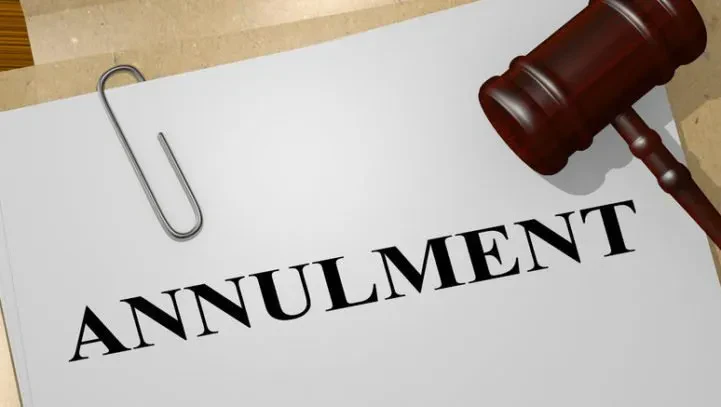 A paper with the word ANNULMENT in bold letters and a wooden gavel resting next to it, symbolizing a legal annulment decision.