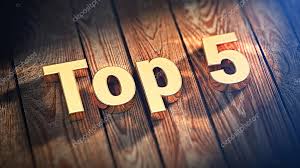 The bold text Top 5 written in large golden letters resting at an angle across dark wooden floorboards under a warm spotlight