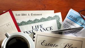 A collection of estate planning documents, including wills and trust agreements, arranged on a wooden desk.