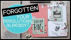An open journal page featuring motivational prompts like "Dream Big" and "Goals" alongside text overlay reading "Forgotten your resolutions already?".