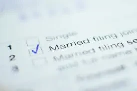 An image of a tax form showing options for filing status, with a blue checkmark next to "Married filing jointly".