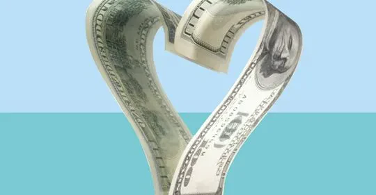 A stylized graphic showing a United States one-hundred-dollar bill folded into the shape of a heart against a split blue and turquoise background.