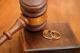 A judge's anvil rests on a wooden tabletop.