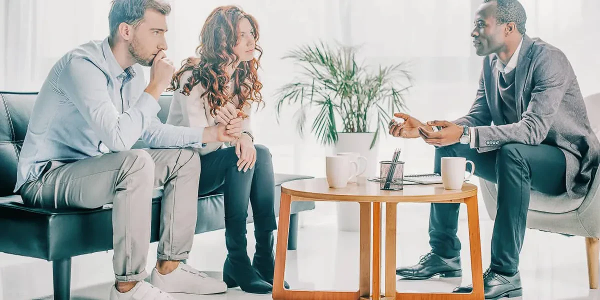Couple talking with a mediator during a divorce