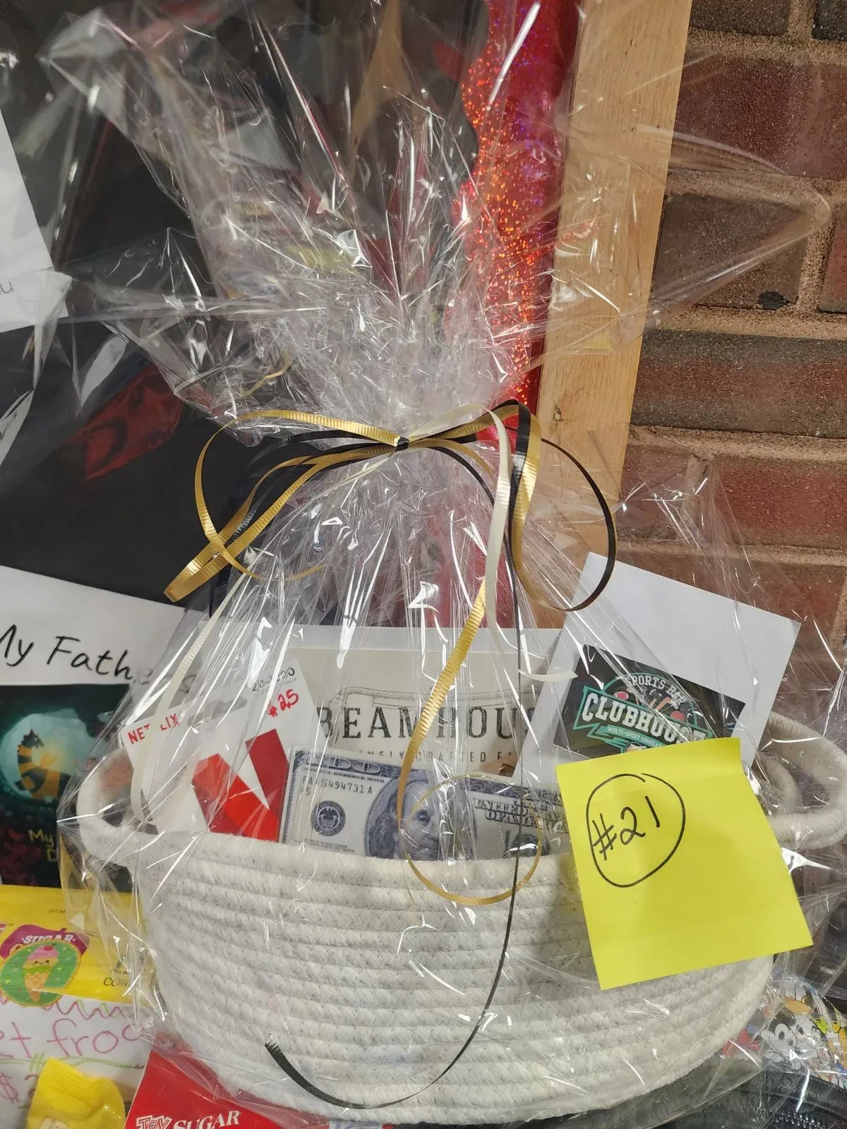 A basket featuring a note and an adjacent open book, suggesting a reading or gift theme.
