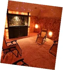 A cozy room featuring several chairs arranged around a warm fireplace.