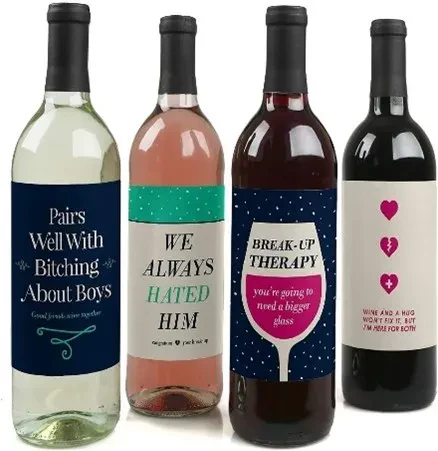 A group of four wine bottles standing side-by-side, each featuring a humorous and comforting custom label designed for someone going through a relationship break-up.