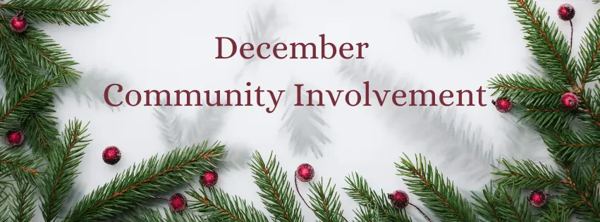 A banner image featuring the text "December Community Involvement" in a maroon, serif font centered on a white background. The bottom, left, and right borders are framed with green evergreen pine branches decorated with small, shiny red Christmas ornaments. Subtle shadows of pine needles are scattered across the white background.